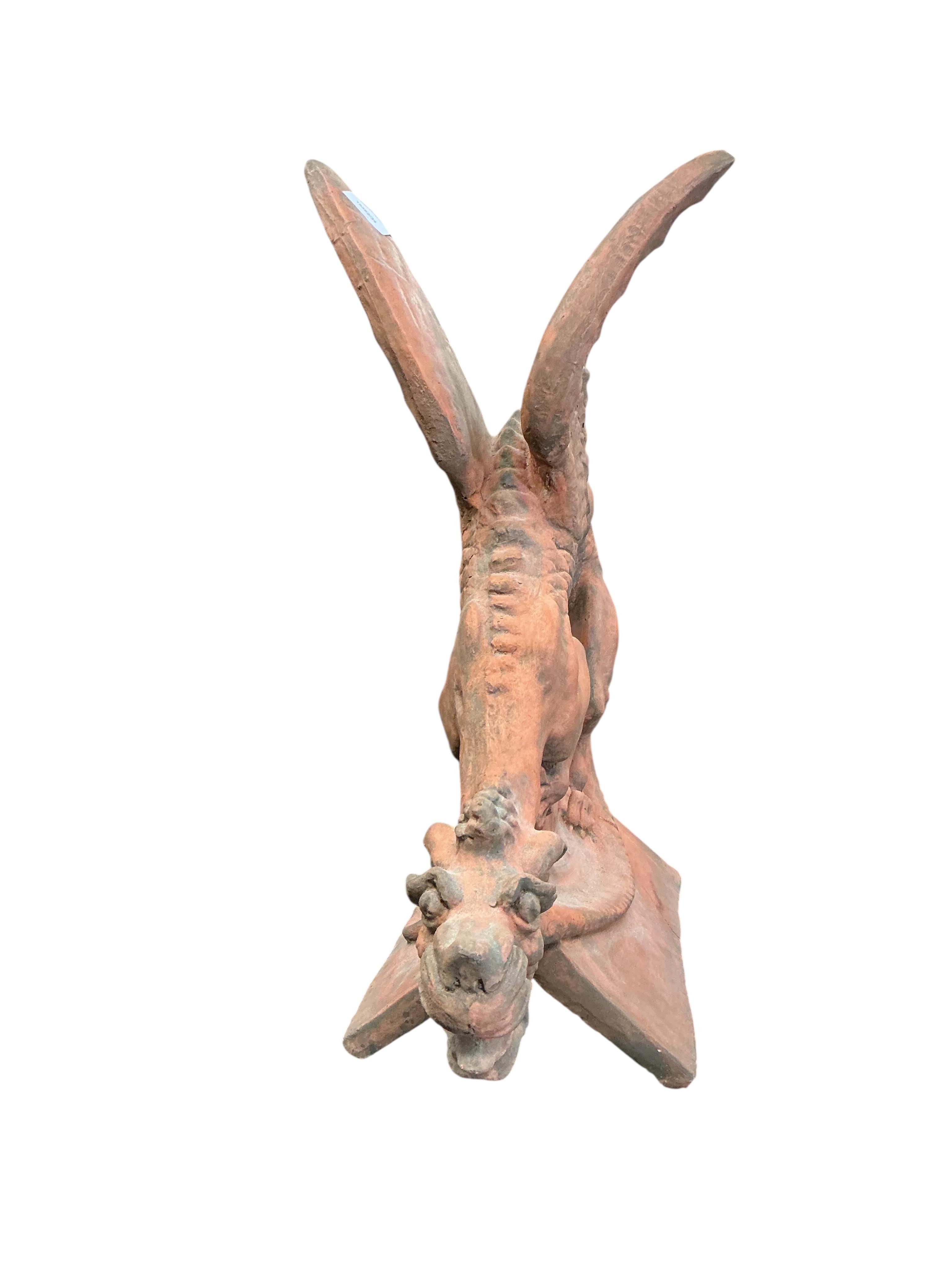 A terracotta gargoyle ridge tile, height 66cm